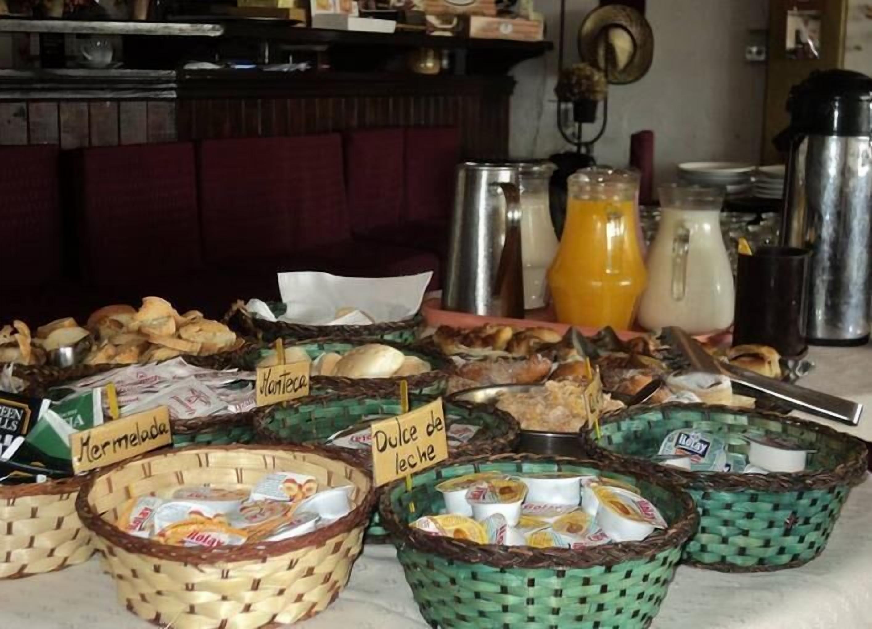 A breakfast buffet with labeled baskets of various food items.