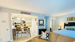 A hotel room with a bed, a sofa, a TV, a desk, and a kitchen area. - Slopeside Studio Wifi Towels Ski in Out (Blue Mountain)