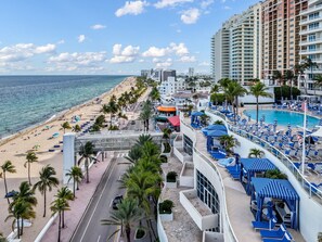 A resort with a beach view, a pool area, and a road leading to the beach. - Gorgeous Private Beachfront 2br (Fort Lauderdale)