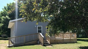 A single-story house with a front deck and a small porch.