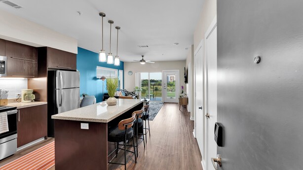 A modern kitchen with a central island, stainless steel appliances, and pendant lighting. - Charming 1-bedroom apartment with AC, WiFi in delightful Cedar Park (Cedar Park)