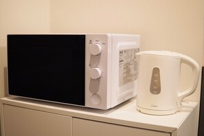 Full-size fridge, microwave, stovetop, rice cooker