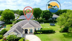 A residential property with a well-maintained lawn, a swimming pool, and a tennis court. - Resort Villa! Pool, Hot Tub & Game Room by Disney! (Kissimmee)