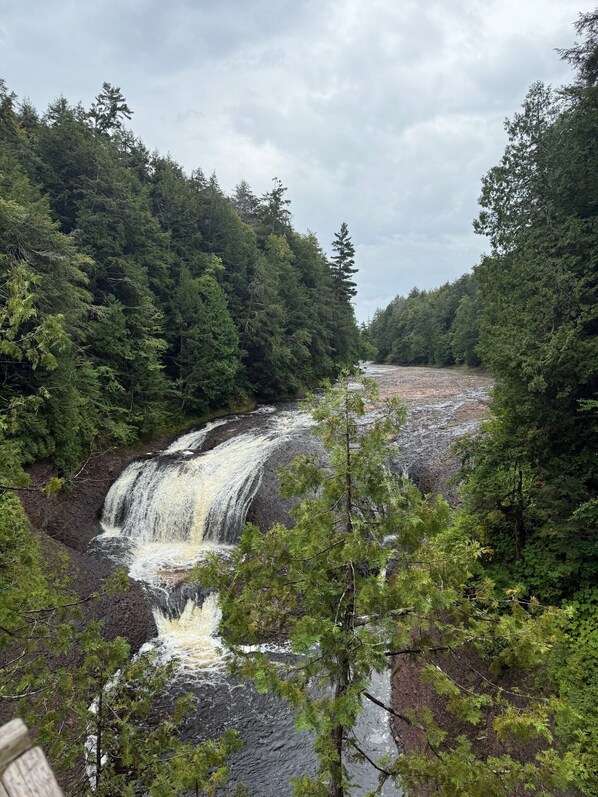 A waterfall surrounded by dense forest. - Cozy Northwoods Cabin – Hiking, Waterfalls, UTV & ATV Trails, Sleeps 4 (Mellen)