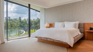 Une chambre moderne avec une grande fenêtre, un lit, une table de chevet et une vue sur la verdure.