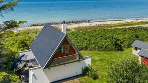 A coastal house with a sloped roof, a balcony, and a view of the sea. - "Luci" - 20m from the sea by Interhome (Martofte)