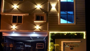 A multi-story building with illuminated windows and a sign that reads "Sri Balaji." - Tech Park Residency (Bengaluru)