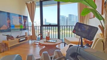 Family Suite, River View | Living room | Video game console