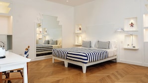 A modern bedroom with a large bed, bedside tables, a desk, and a mirror. - Tasso 41 House Sorrento City Center (Sorrento)