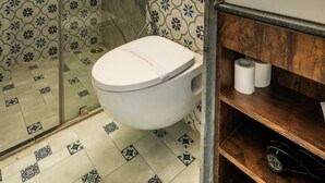 A bathroom with a shower, toilet, and sink.