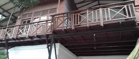 A multi-story building with a balcony and a staircase.
