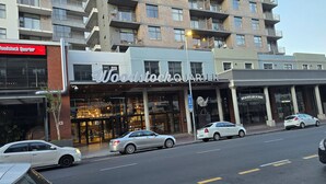 A multi-story building with a prominent 'Woodstock Quarter' sign. - Hoe Sweet Home (Cape Town)