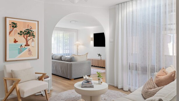 A living room with a sofa, armchair, coffee table, and artwork on the wall. - Solace Jervis Bay - 3BR relaxed beach side living (Vincentia)