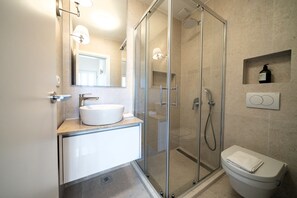 Shower, hair dryer, towels, toilet paper