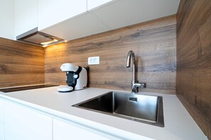 Fridge, coffee/tea maker, electric kettle, cookware/dishes/utensils