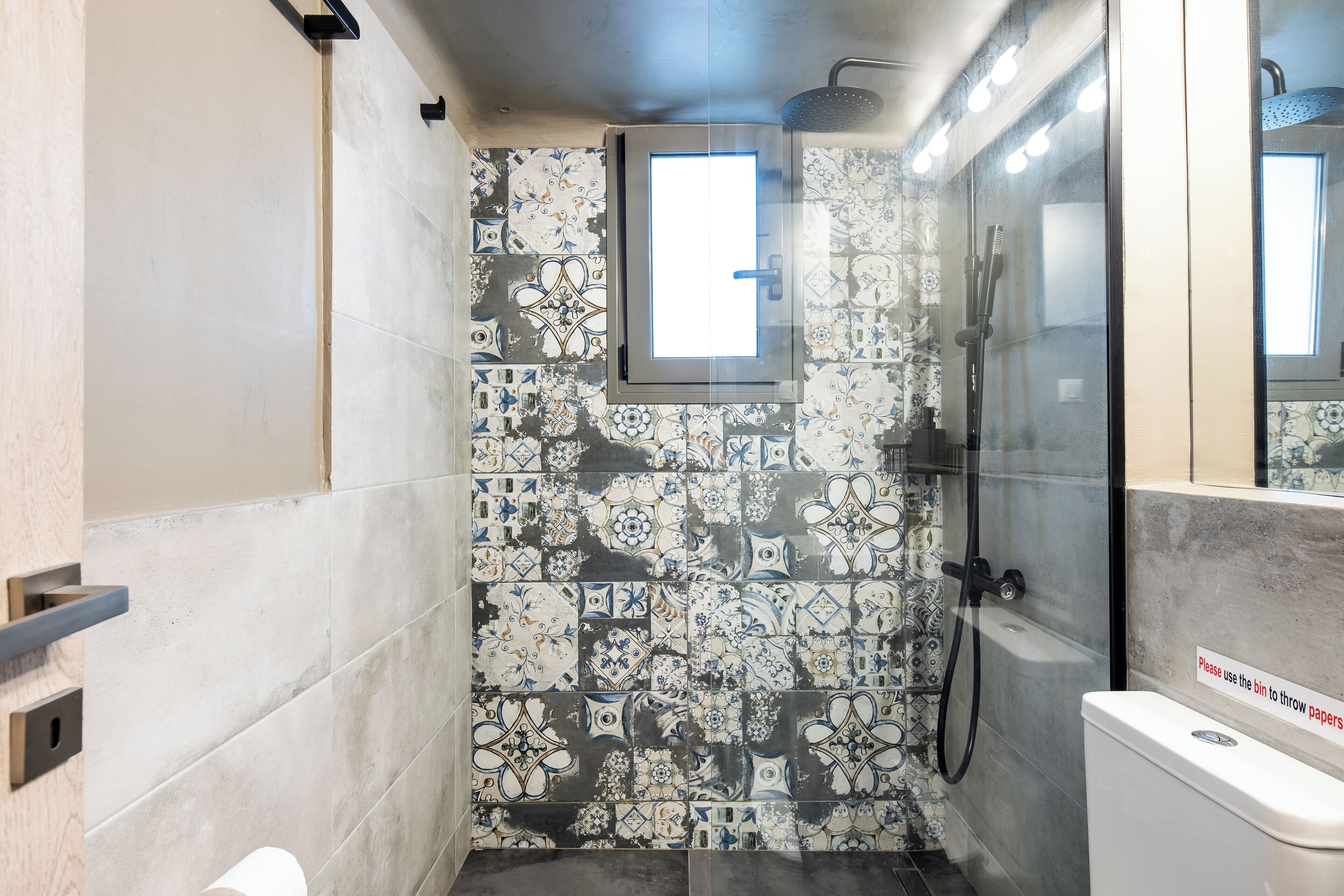 A bathroom with a shower, a toilet, and a sink.
