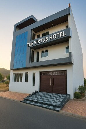 A modern two-story hotel with a prominent sign reading "THE VIRTUS HOTEL". - Virtus Hotel NewlyBuilt Greater Noida (Greater Noida)
