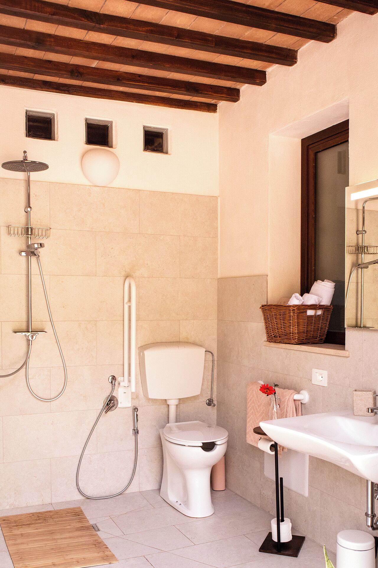 A modern bathroom with a shower, toilet, and sink.