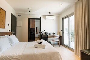 A hotel room with a bed, a desk, a chair, a small table, and a large window with curtains. - Ermou 26 Hotel (Athens)