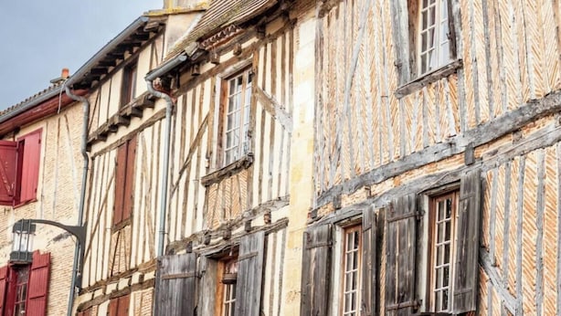 A traditional half-timbered building with exposed wooden beams and a steeply pitched roof.