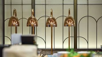 A room with a decorative metal partition and a table with various items.