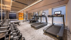 A gym with treadmills, dumbbells, and exercise equipment. - Novotel Hangzhou Yuhang (Hangzhou)