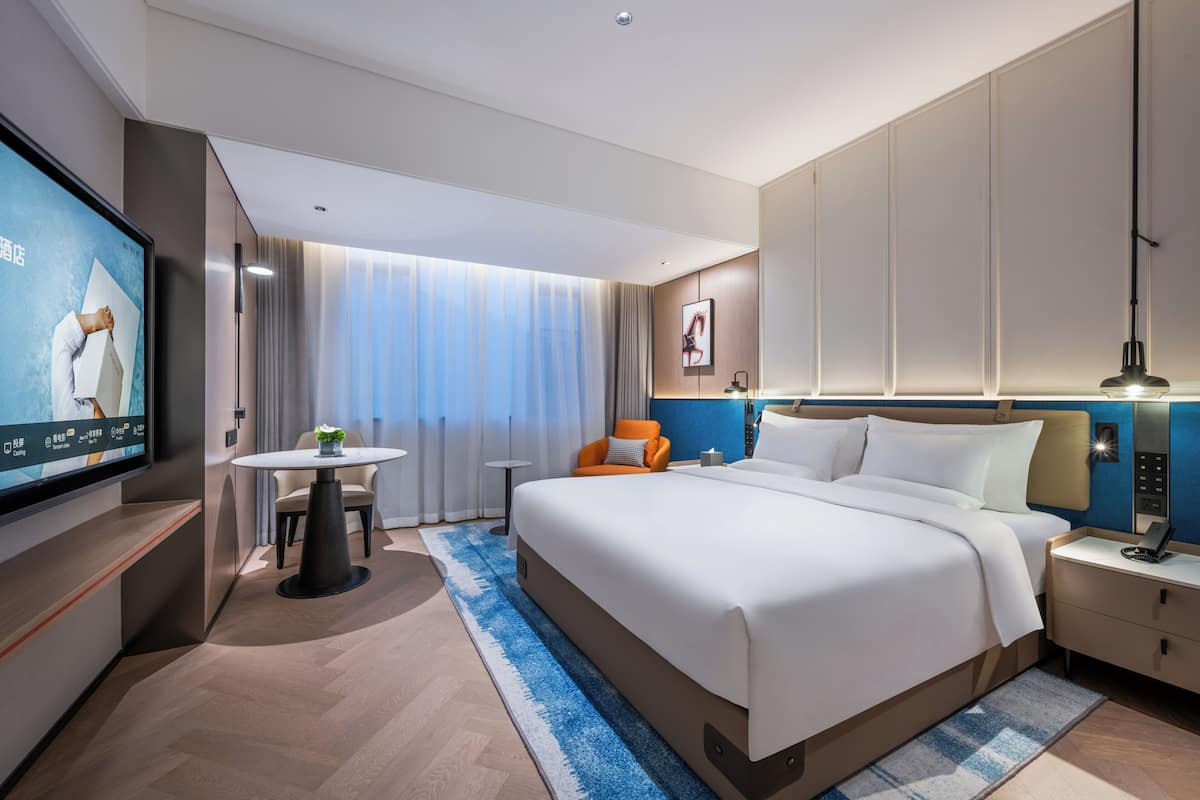 Luxe beddengoed, donsdekens, een minibar met enkele gratis items