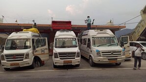 Three white vans parked in front of a building with a sign that reads "HOTEL VISION RESIDENCY". - Hotel Vijay Residency Barkot (Rajgarhi)