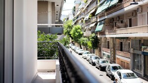 A narrow urban street with parked cars and multi-story buildings. - Spark 2-Bedroom Apartment in Athens (Athens)