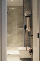 Shower, hair dryer, slippers, towels