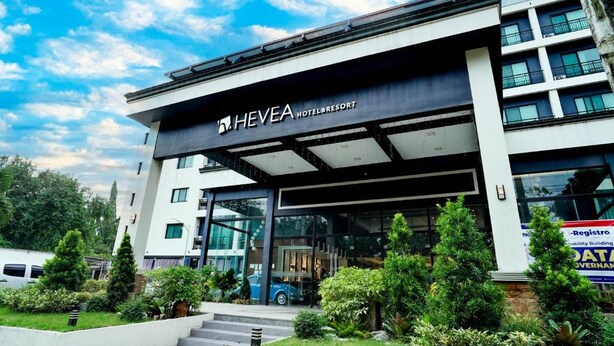 A modern hotel with a prominent entrance, glass facade, and landscaped surroundings. - Dancenter Luxury Retreat Angeles City (Angeles City)