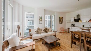A modern apartment with a living area, dining space, and kitchen.