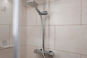 A showerhead mounted on a wall with a control panel below. - Studio 'Karlsplatz' with Wi-Fi (Freiamt)