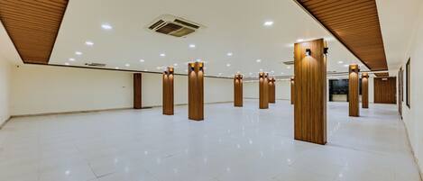 A spacious, well-lit interior with a high ceiling and wooden beams.