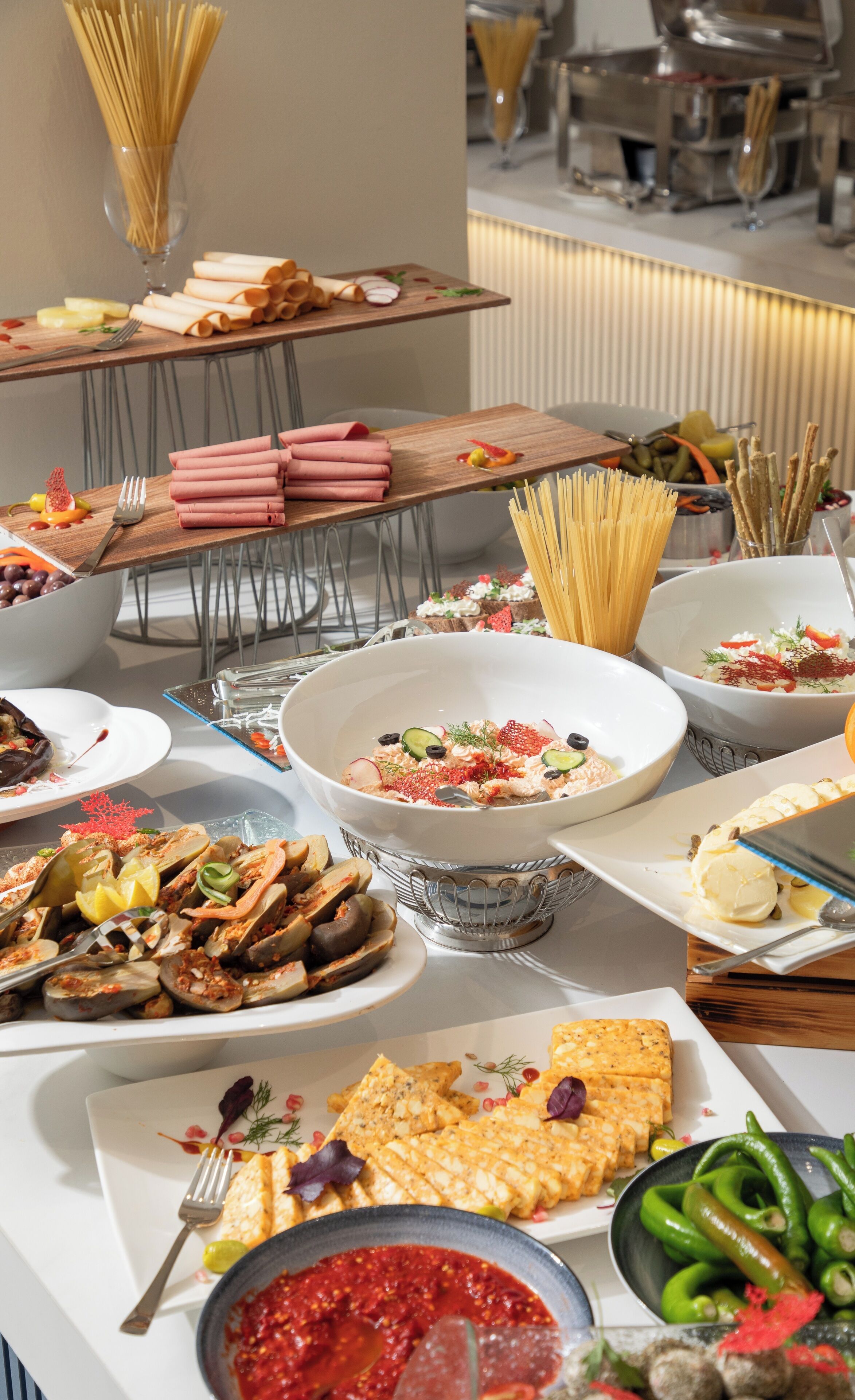 A buffet with various dishes including pasta, seafood, and salads.