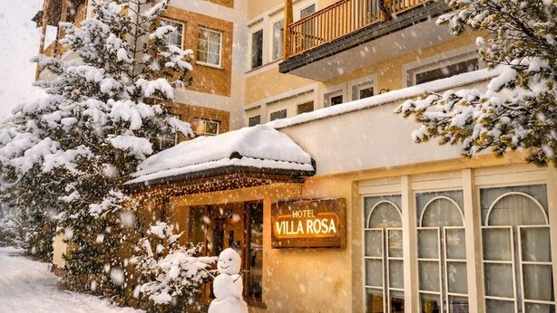 A multi-story hotel with a snow-covered exterior, balconies, and a sign reading 'Hotel Villa Rosa.' - HOTEL VILLA ROSA (Campitello di Fassa)