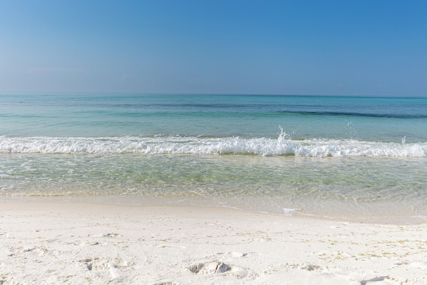 A beach with clear turquoise water and white sand.