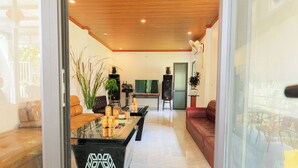 A modern living room with a glass partition, a sofa, a coffee table, and a TV. - Heartfelt Hideaway (Nam Hoa Lu)