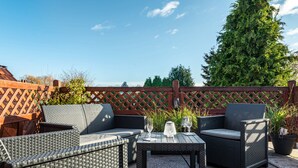 An outdoor patio with wicker furniture, a table, and potted plants. - Holiday Appartment "Anne" with Balcony and Wi-Fi (Bremervörde)