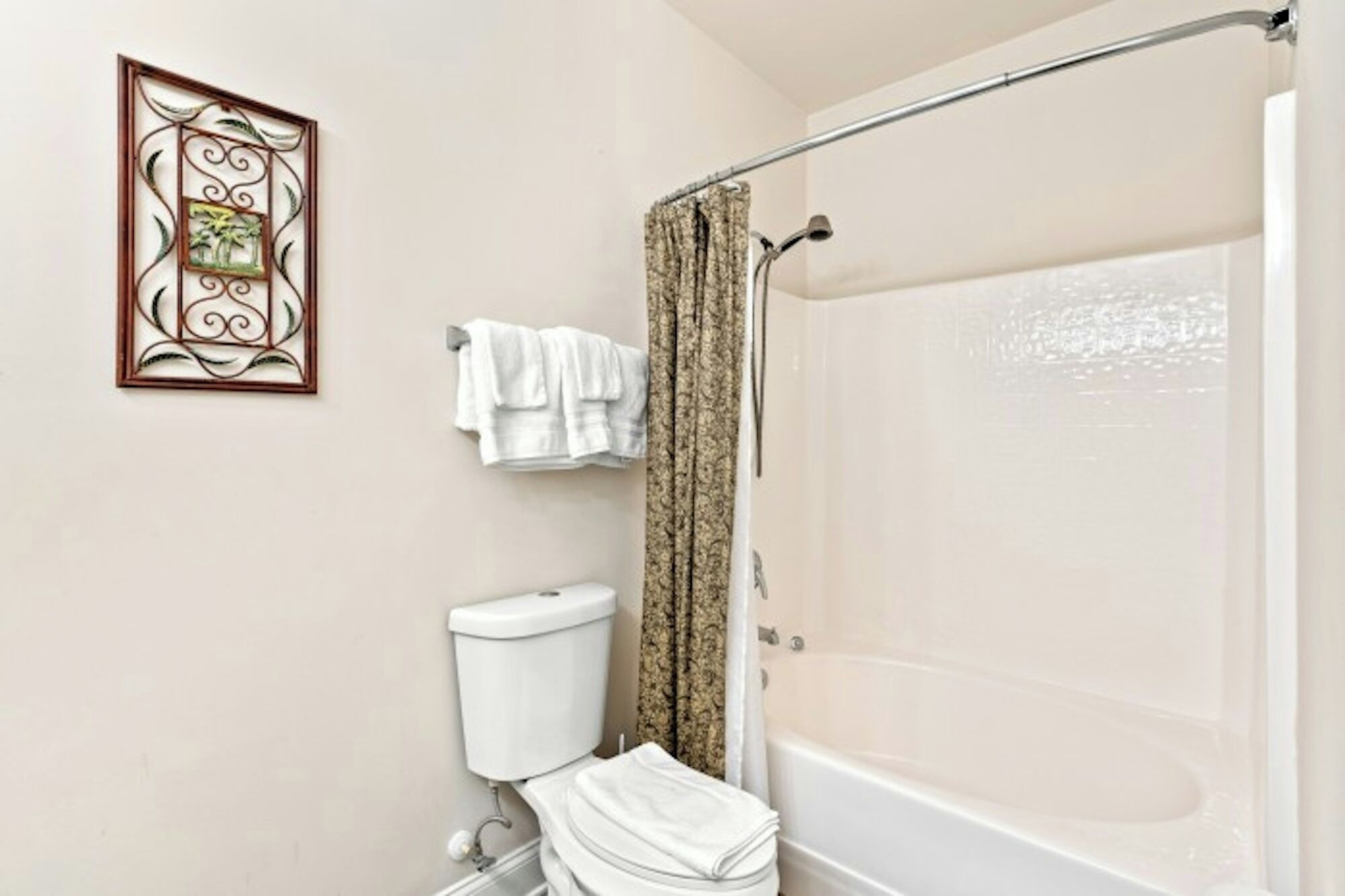 A bathroom with a toilet, a shower, and a bathtub.