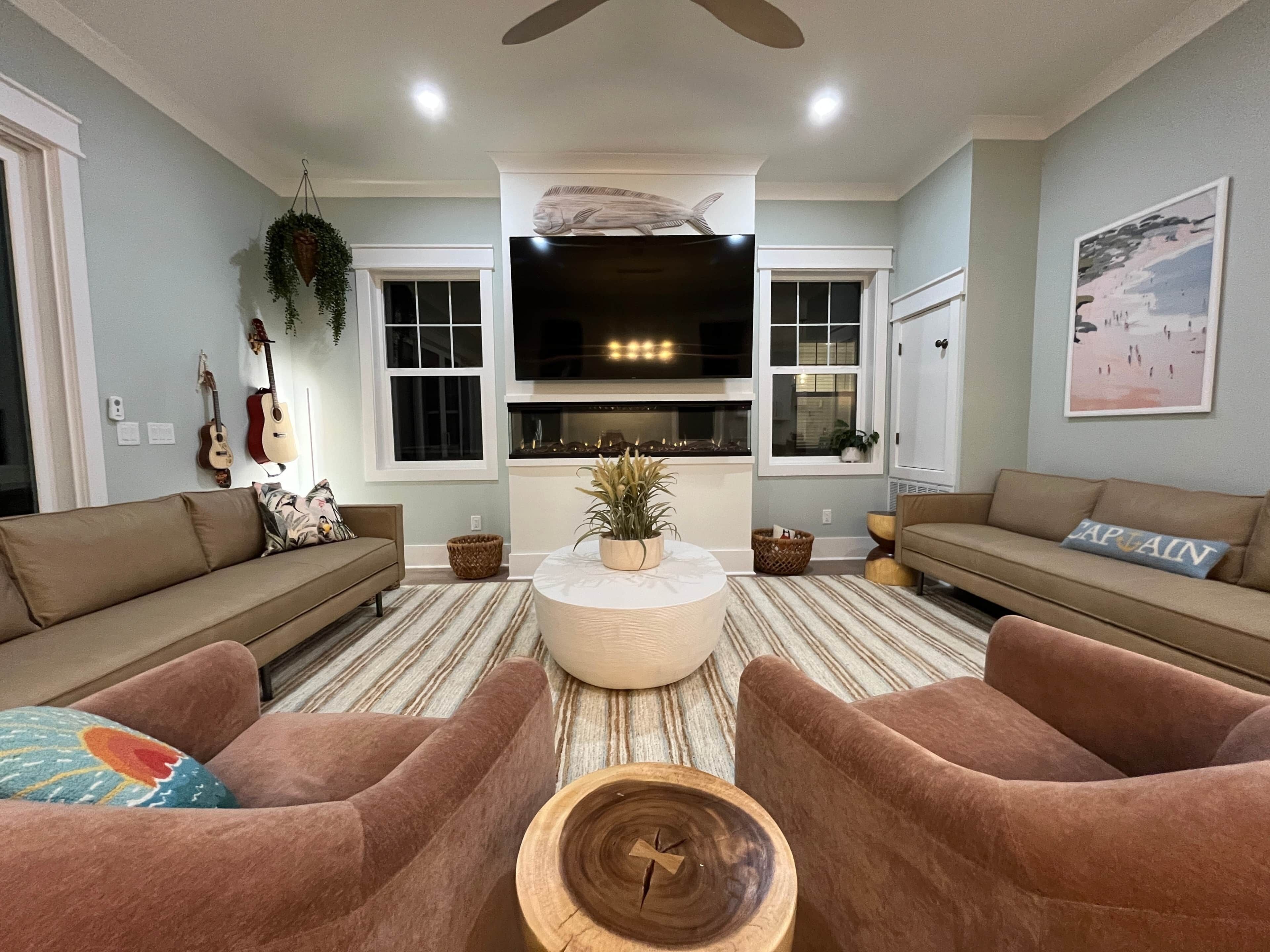 A living room with two sofas, a coffee table, a fireplace, and a TV.