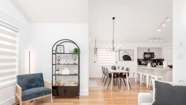 A modern kitchen with white cabinets, a microwave, and a coffee machine. - Ellerslie - Sleeps 6 - AC - Garage (Edmonton)