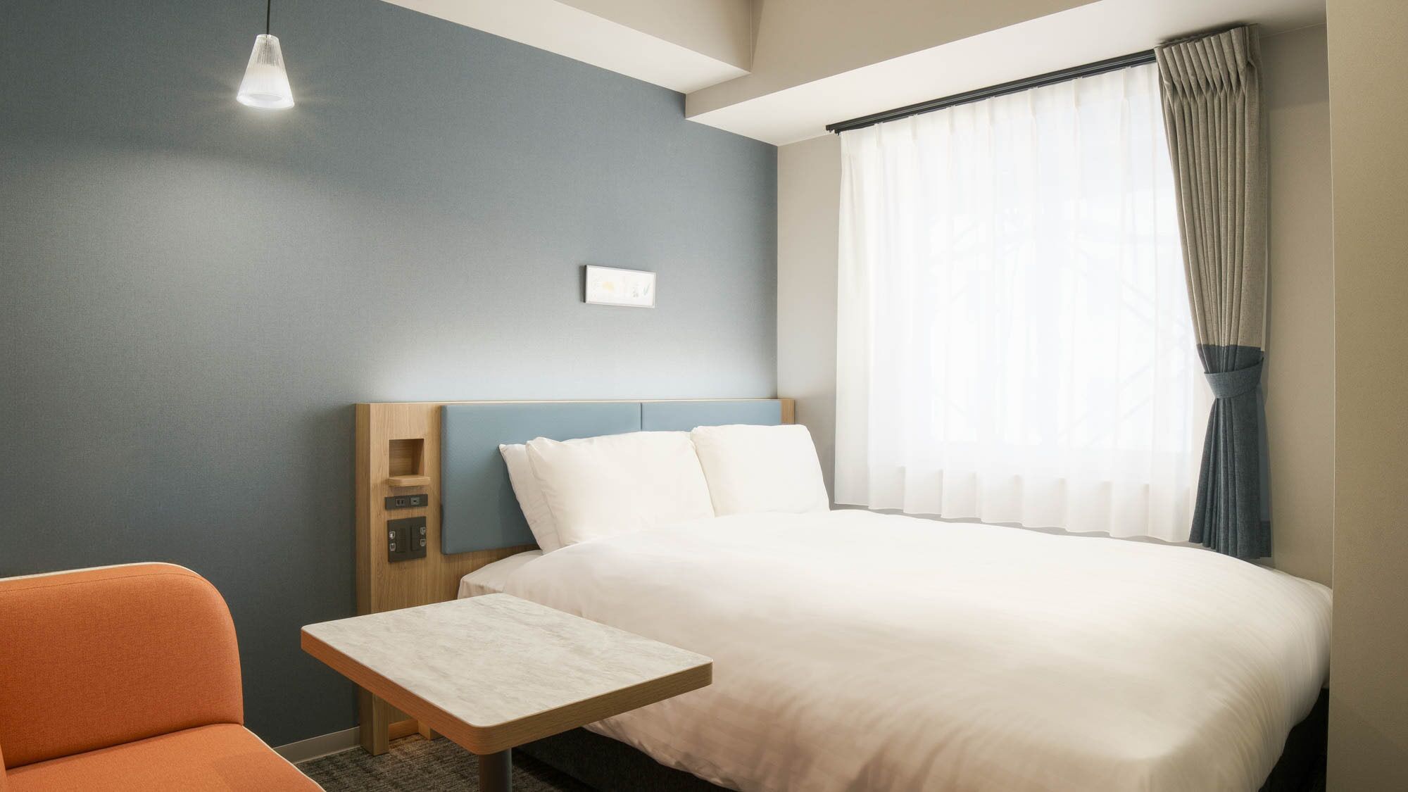 Premium bedding, laptop workspace, blackout drapes, soundproofing
