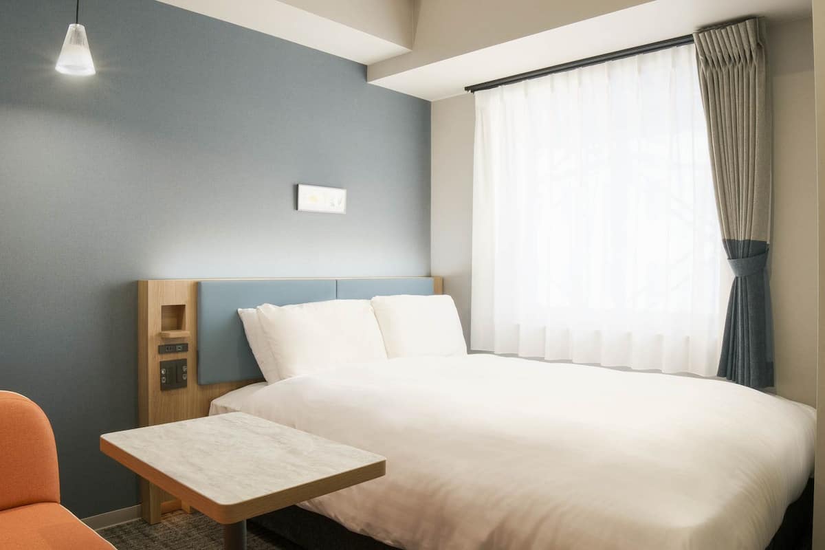 Luxe beddengoed, een laptopwerkplek, verduisterende gordijnen