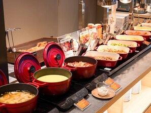A buffet with various dishes in red and black pots, a Panasonic rice cooker, and a sign indicating a potage dish. - Comfort Hotel ERA Sapporo North (Sapporo)