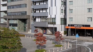 A modern hotel building with multiple floors, a prominent Comfort Hotel sign, and an APA Hotel sign. - Comfort Hotel Mito (Mito)