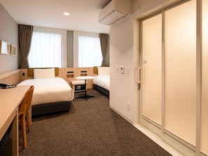 A hotel room with two beds, a desk, a chair, a small table, and a wardrobe. - Comfort Hotel Mito (Mito)