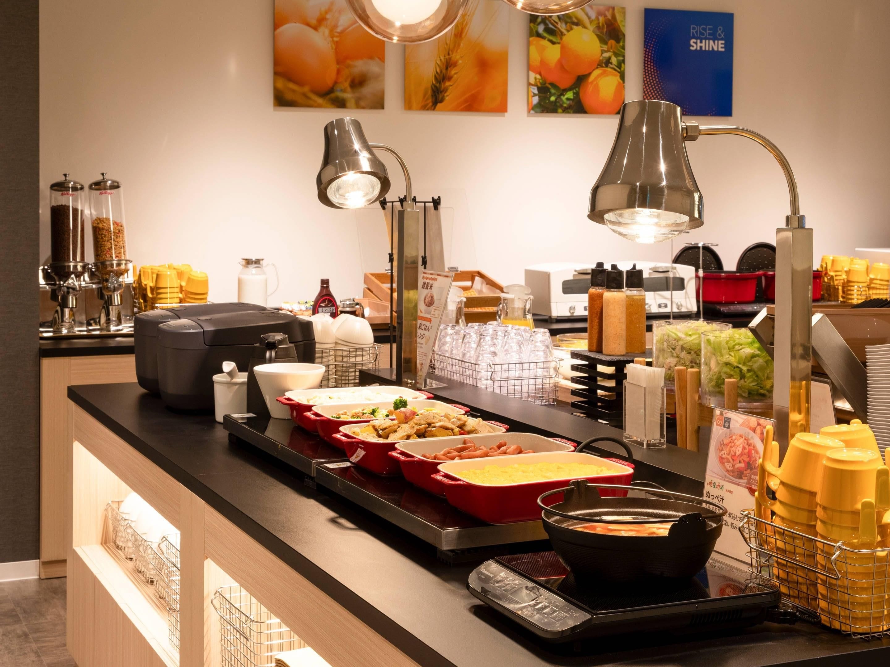 A buffet setup with various food items and condiments.