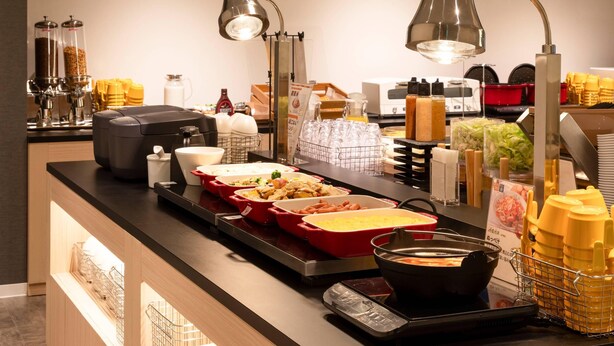 A buffet setup with various food items and condiments. - Comfort Hotel Mito (Mito)