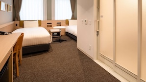 A hotel room with two beds, a desk, a chair, a small table, and a wardrobe. - Comfort Hotel Mito (Mito)